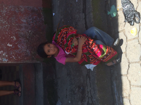 Chichicastenango - Jong meisje zorgt voor baby op drukke markt in Guatemala